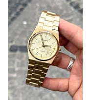 Gold Renk Yuvarlak Kadran Detay Şık ve Modern Tasarım Gold Renk Çelik Kasa ve Kordonlu Kol Saati