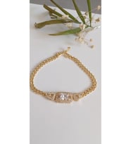 ÇELİK BİLEKLİK KADIN GOLD BAGET TAŞLI ALTIN KAPLAMA  ANTİALERJİK KARARMAZ 18 CM