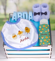 eJOYA Ahşap Sandıkta Kişiye Özel Önlük Biberon Taş İsimlik Ve Patik Bebek Hediye Seti 109525 (Mavi)